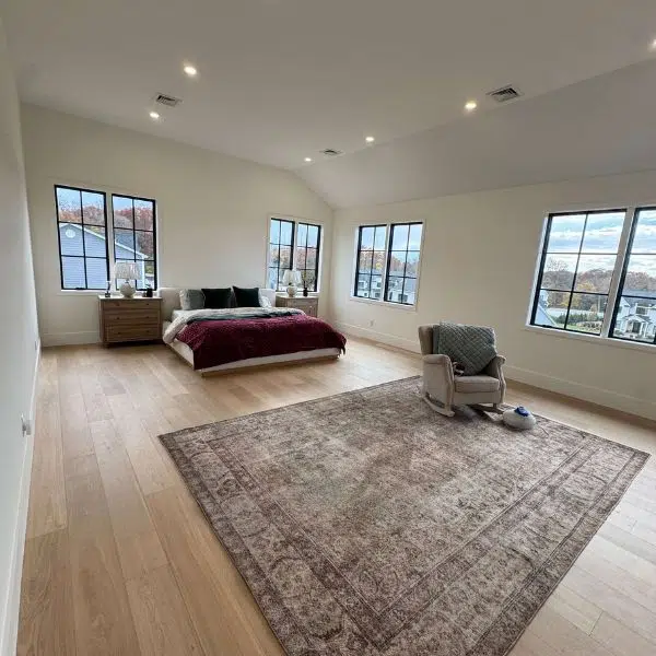 Bedroom with wood floors and a rug