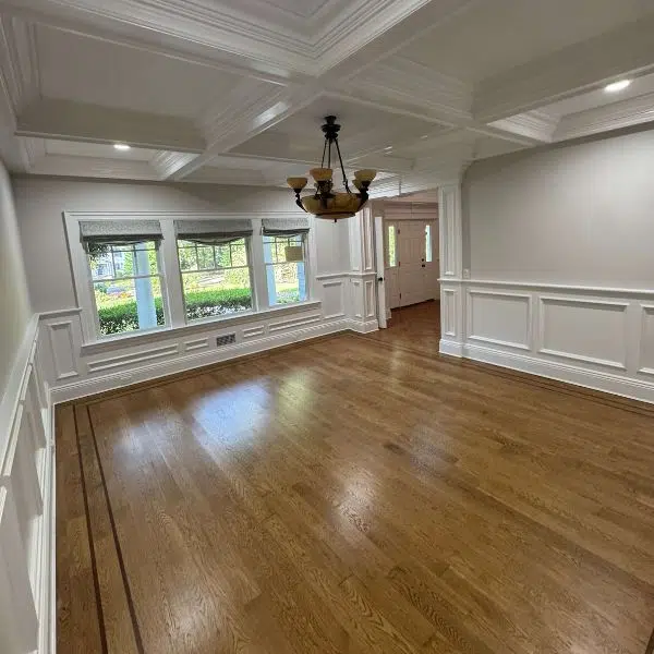 Empty dining room with paneled walls and wood floor