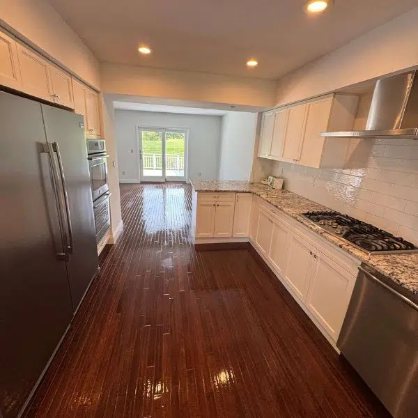 Empty kitchen with cabinets and wood floors